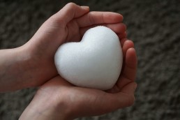 person holding a white heart