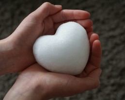 person holding a white heart